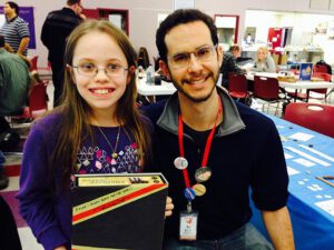 Designer Ben Rosset signs a copy of Mars Needs Mechanics for Rayne